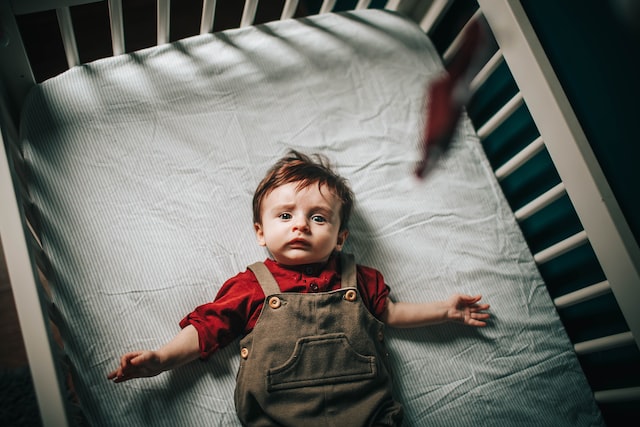 Baby laying in a toy-free crib